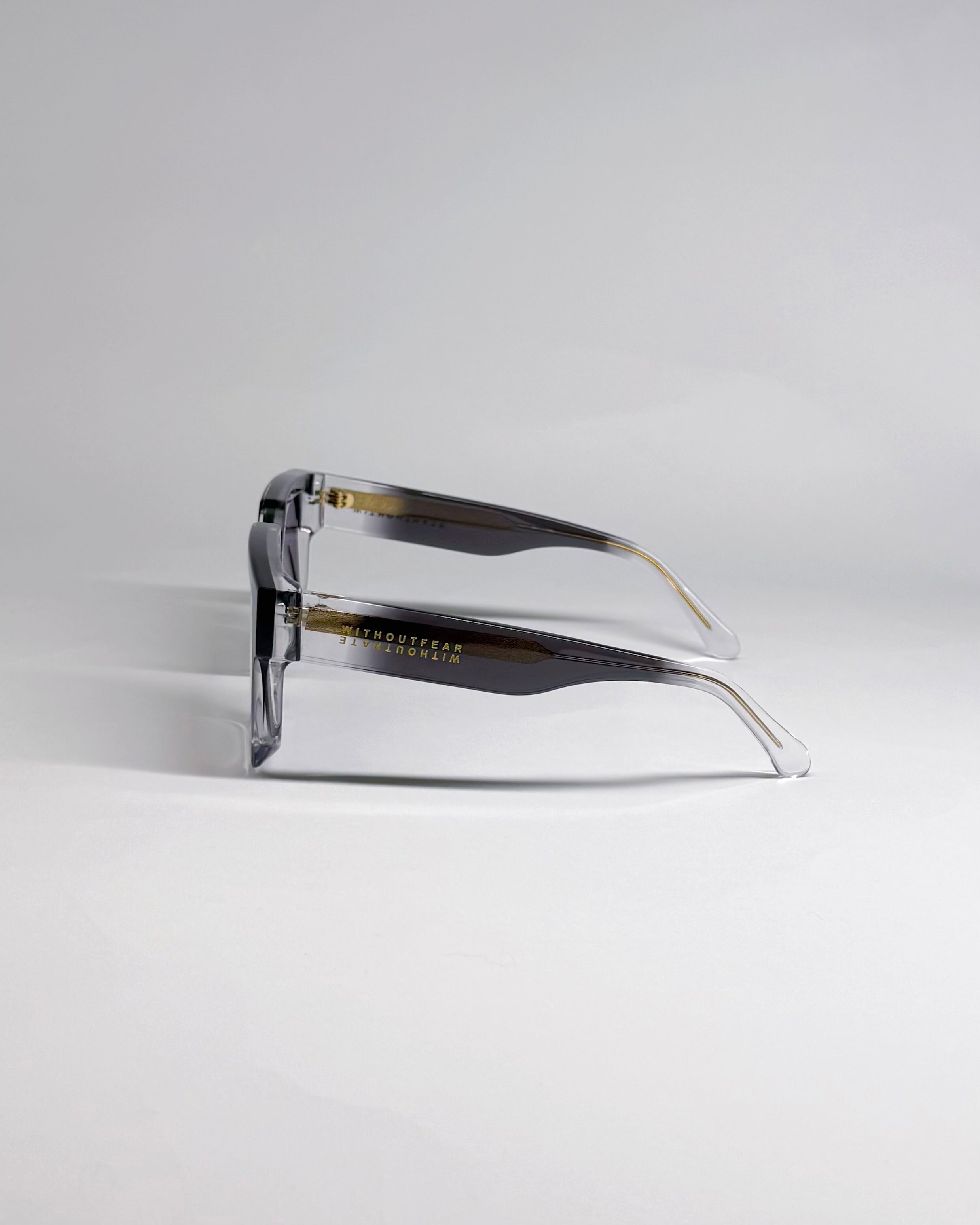 wfwh cannon sunglasses with gold accents on a light gray background side